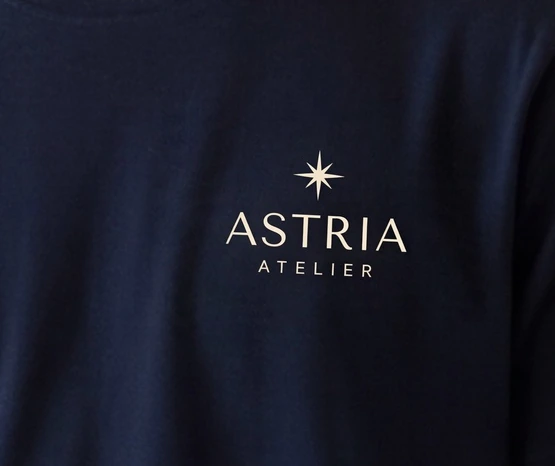 ASTRIA Atelier: small chest logo in a wide scene, detail in the finished frame