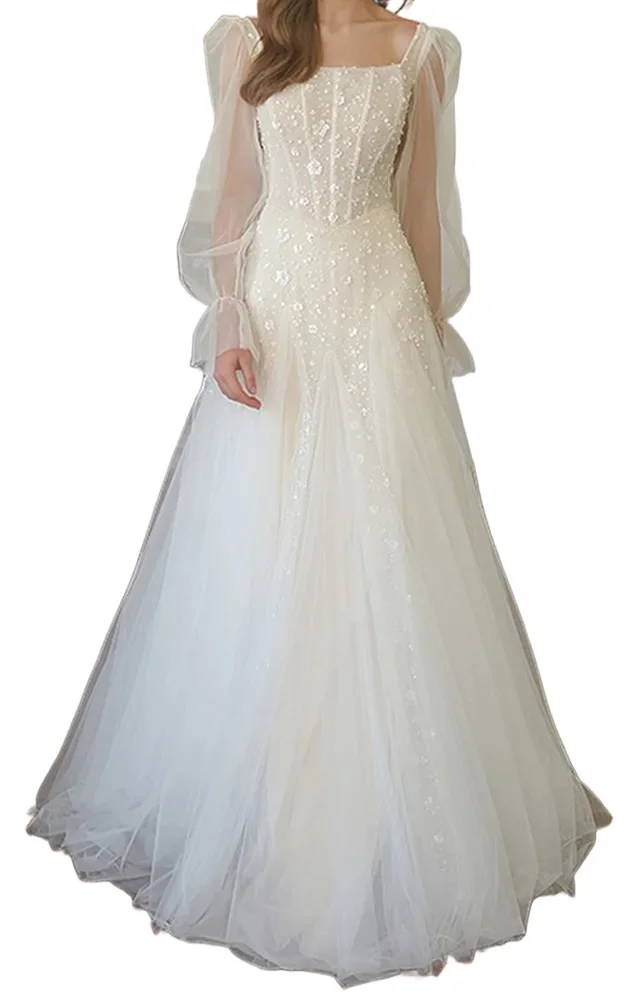 Off-white beaded tulle wedding dress reference on a model