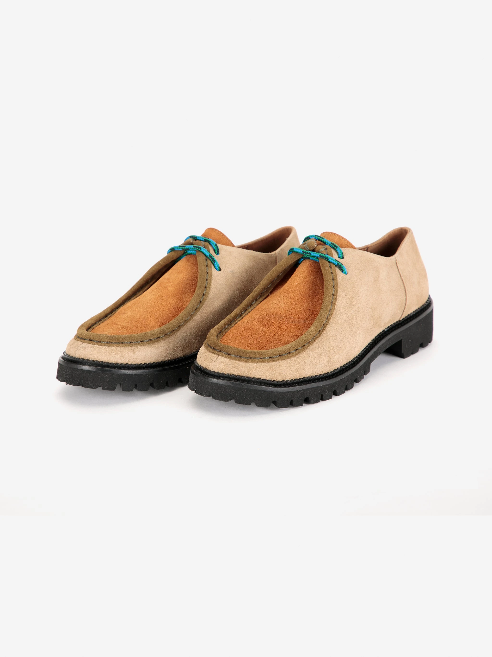 Original front three-quarter packshot of tan suede wallabee shoes with teal laces and dark soles