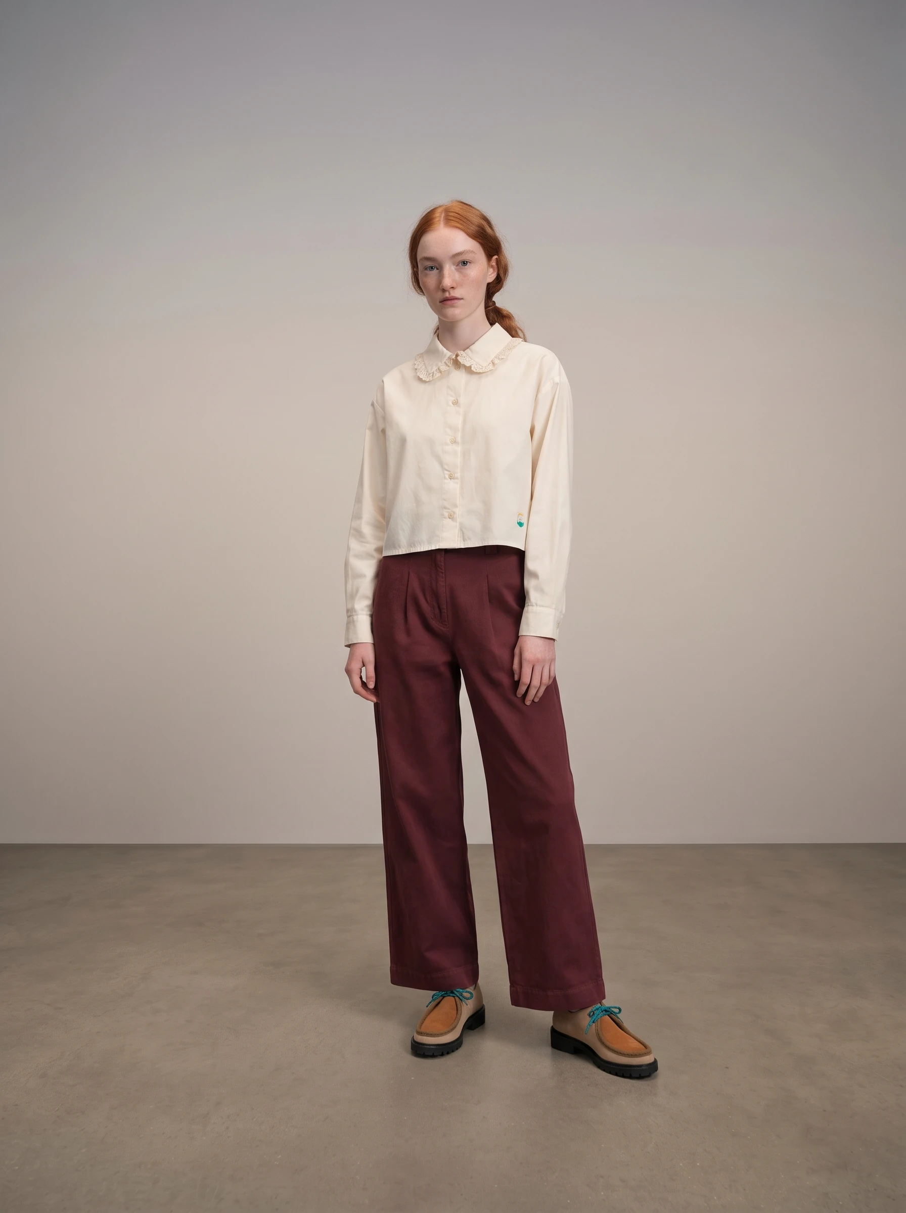 First reference-based full-length image with the cream shirt, burgundy trousers and suede shoes
